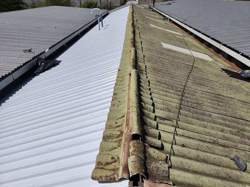 Asbestos sheet replacement — old and new sheeting side by side