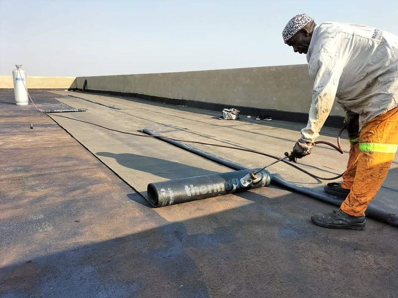 Torch-on waterproofing membrane being applied on a flat concrete roof